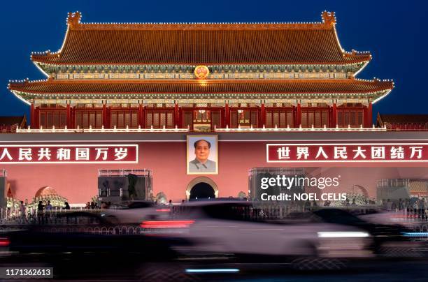 Vehicles drive past the Tiananmen Gate in Beijing, ahead of the 70th anniversary of the founding of the People's Republic of China, on September 26,...