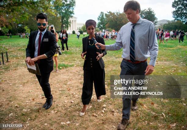 Representative Ilhan Omar speaks with a member of the press after attending the "People's Rally for Impeachment" on Capitol Hill in Washington, DC on...