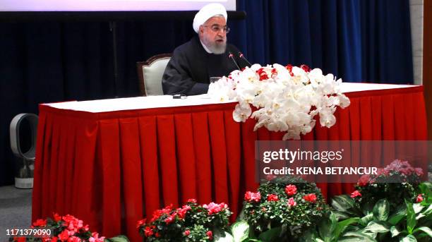 Iranian President Hassan Rouhani speaks during a press conference in New York on September 26, 2019. - Rouhani challenged countries who accused Iran...