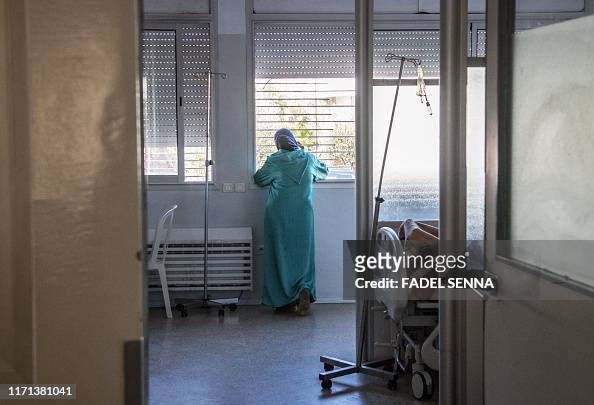 A relative of a Moroccan AIDS patient looks out the window in the ...