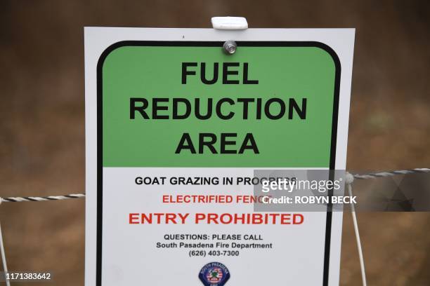 Sign blocks off a fuel reduction area where goats are grazing as part of fire prevention efforts, September 26, 2019 in South Pasadena, California. -...