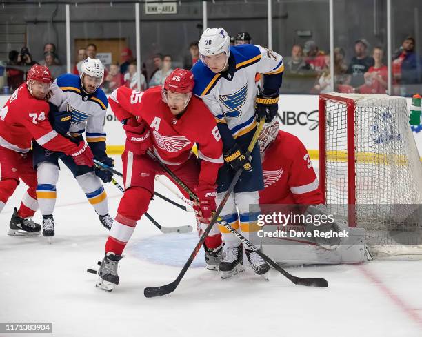 Cal Pickard of the Detroit Red Wings follows the play as teammate Danny DeKeyser battles in front with Oskar Sundqvist of the St. Louis Blues in the...