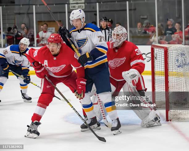 Cal Pickard of the Detroit Red Wings follows the play as teammate Danny DeKeyser battles in front with Oskar Sundqvist of the St. Louis Blues in the...