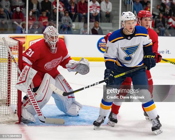 Cal Pickard of the Detroit Red Wings follows the play as teammate Dennis Cholowski battles in front of the net with Ryan Olsen of the St. Louis Blues...