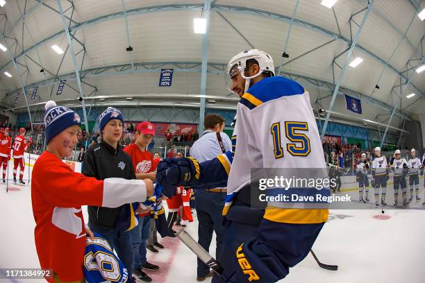 Robby Fabbri of the St. Louis Blues gives a jersey to a young fan after a pre-season Kraft Hockeyville game against the Detroit Red Wings at the...