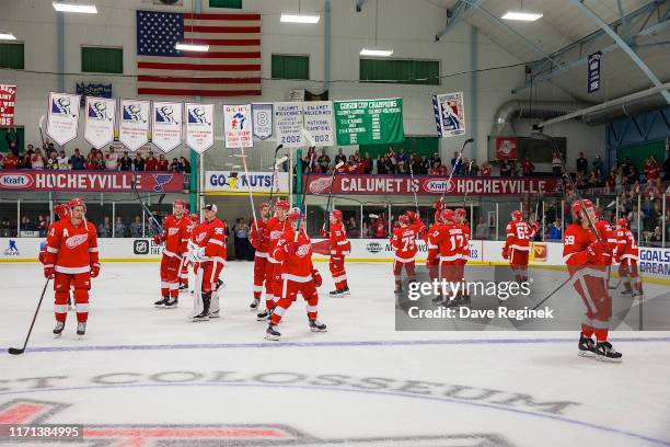 The Detroit Red Wings salute the fans after a pre-season Kraft Hockeyville game against the St. Louis Blues at the Calumet Colosseum on September 26,...