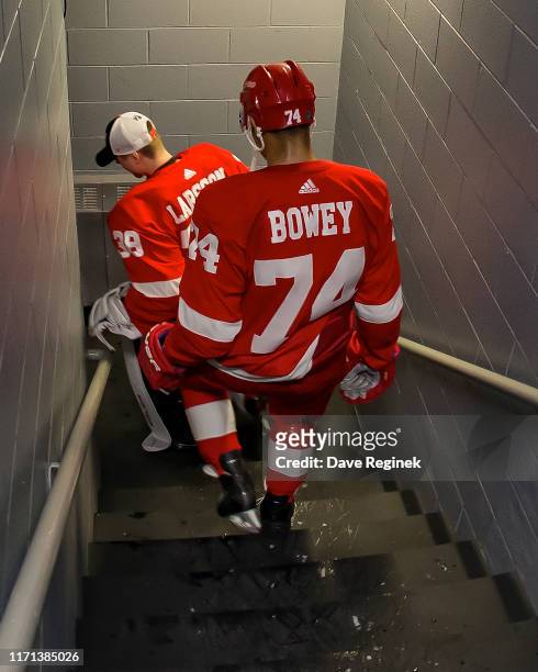 Madison Bowey and Filip Larsson of the Detroit Red Wings walk down the stairs to the locker room after a pre-season Kraft Hockeyville game against...