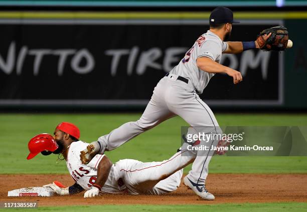 Brian Goodwin of the Los Angeles Angels beats the throw to Jack Mayfield of the Houston Astros for a double in the second inning but hurt his back on...
