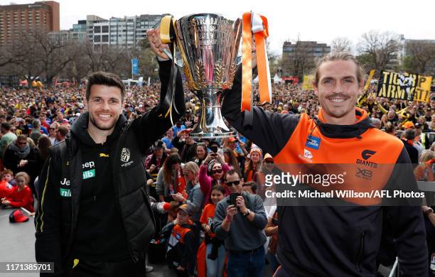 Trent Cotchin of the Tigers and Phil Davis of the Giants pose with the premiership cup during the Toyota AFL Grand Final Parade on September 27, 2019...