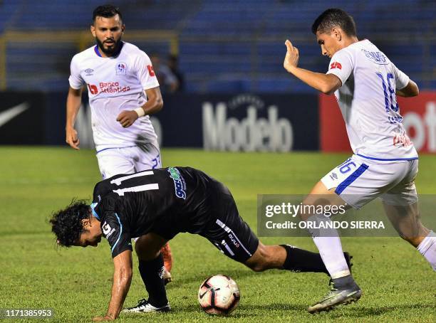Jhonny Leveron of Honduras' Olimpia and Agustin Herrera of Guatemala Comunicacione, vie for the ball during a Concacaf League football match at...