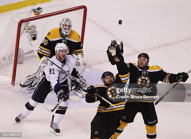 Johnny Boychuk of the Boston Bruins, Gregory Campbell of the Boston Bruins and Tim Thomas of the Boston Bruins defend against Steven Stamkos of the...