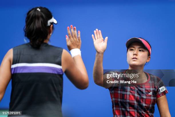 Makoto Ninomiya of Japan and Zhaoxuan Yang of China react during the Ladies Doubles semifinal against Yingying Duan of China and Veronika Kudermetova...