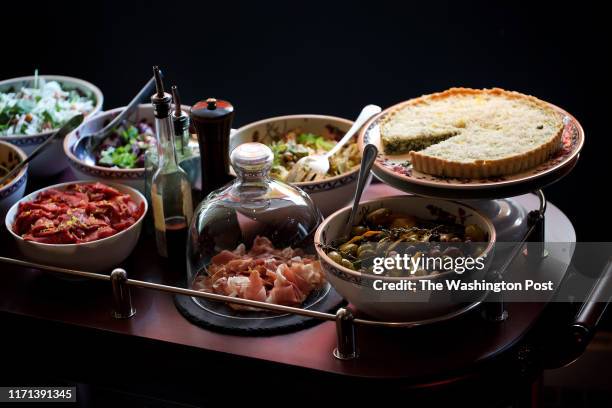 The antipasti cart including Marinated Olives, Confit Tuna & White Bean Salad, Artichoke Scafata, Figs, Goat Cheese and Arugula Salad, Focaccia di...