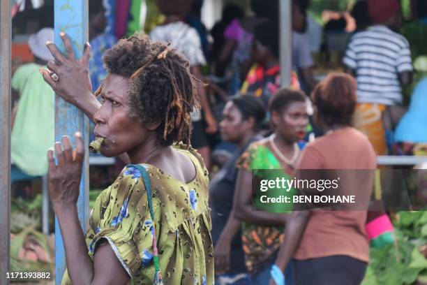 In this picture taken on January 11 a woman chews betal nut at a market in Arawa, which was the capital and largest town in the autonomous region of...