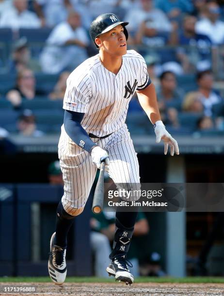 Aaron Judge of the New York Yankees watches the flight of his eighth inning home run against the Oakland Athletics at Yankee Stadium on August 31,...
