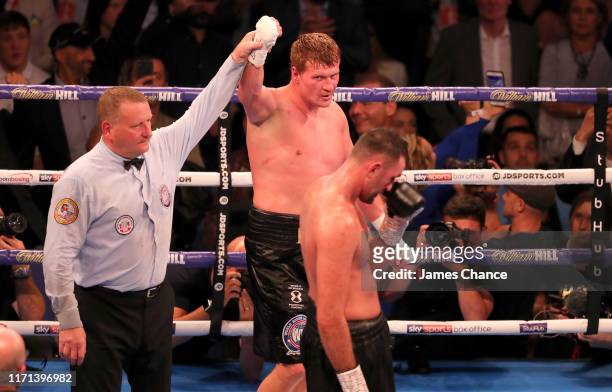Alexander Povetkin celebrates victory as Hughie Fury looks on during the WBA International Heavyweight Title contest between Hughie Fury and...