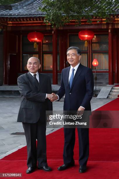 Wang Yang, chairman of the Chinese People's Political Consultative Conference shakes hands Cambodia's King Norodom Sihamoni at Diaoyutai State...