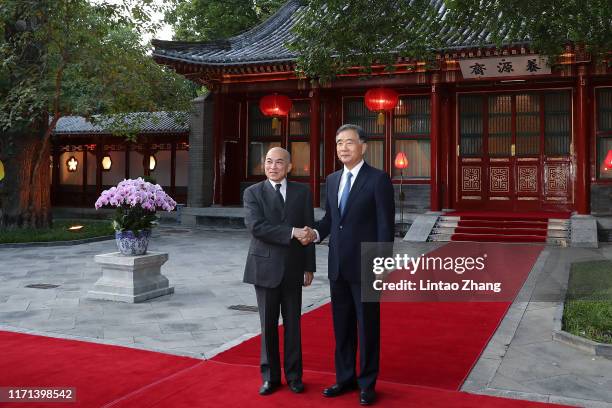 Wang Yang, chairman of the Chinese People's Political Consultative Conference shakes hands Cambodia's King Norodom Sihamoni at Diaoyutai State...