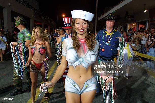 People dressed in costumes and body paint walk in a parade October 27, 2001 during the Key West, Florida Fantasy Fest.
