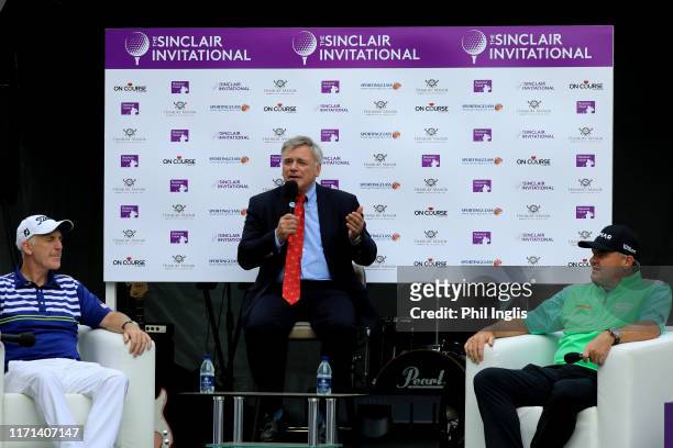 Paul Lawrie of Scotland and Phillip Price of Wales entertain the crowds in a Q & A hosted by Ken Schofield during the second round of the Sinclair...