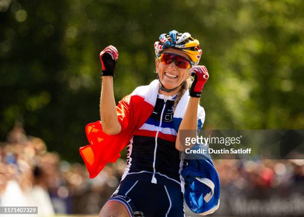 Pauline Ferrand Prevot of France celebrates as she crosses the finish line in the Women's Elite Cross-country Olympic distance race at the UCI...