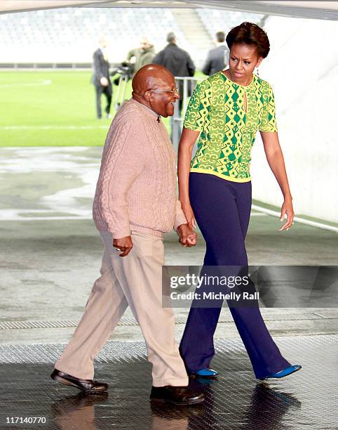 Michelle Obama, first lady of the United States of America walks with Nobel Prize Peace Laureate, Archbishop Desmond Tutu, as they attend a Youth...