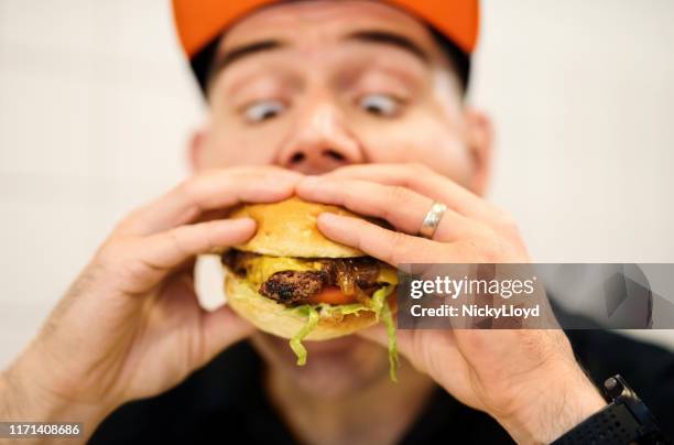 crazy for burger - over-eating stock pictures, royalty-free photos & images
