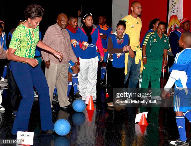 Michelle Obama, first lady of the United States of America takes part in an exercise watched by Nobel Prize Peace Laureate, Archbishop Desmond Tutu,...