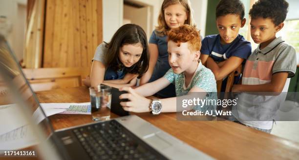 kids watching a movie on digital tablet - redhead gamer stock pictures, royalty-free photos & images