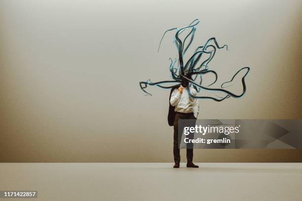 businessman with growing tentacles - tentacle stock pictures, royalty-free photos & images