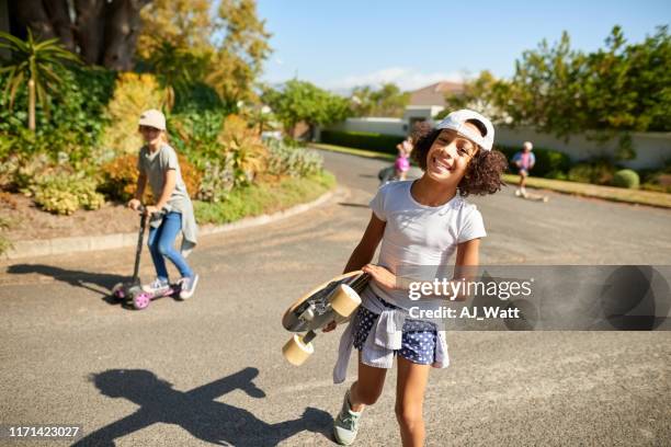 today is a fun day with skateboards - girl riding scooter stock pictures, royalty-free photos & images