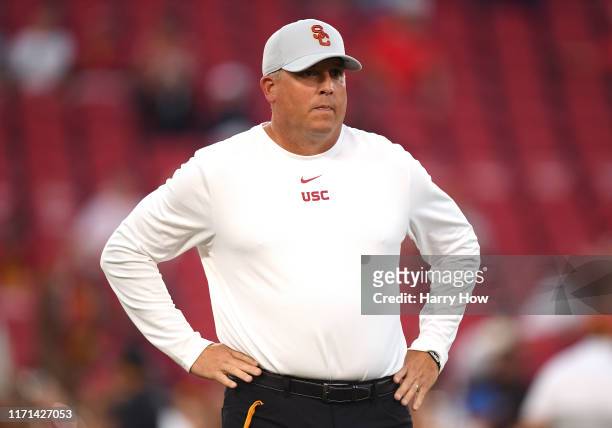 Head coach Clay Helton of the USC Trojans watches warm up before the game against the Fresno State Bulldogs at Los Angeles Memorial Coliseum on...