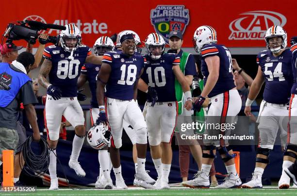 Seth Williams of the Auburn Tigers celebrates with Bo Nix of the Auburn Tigers after scoring the game winning touchdown against the Oregon Ducks in...