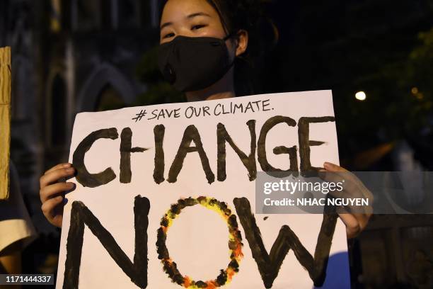 Activists hold placards during a demonstration as part of the global climate strike week, in Hanoi on September 27, 2019.