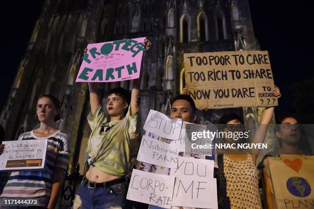 Activists hold placards during a demonstration as part of the global climate strike week, in Hanoi on September 27, 2019.