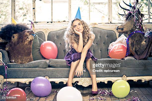 party-animals und schöne junge frau - stressed young woman sitting on couch stock-fotos und bilder