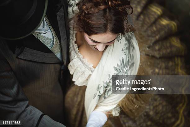 victorian romantic couple whirls while dancing together. - period costume stock pictures, royalty-free photos & images