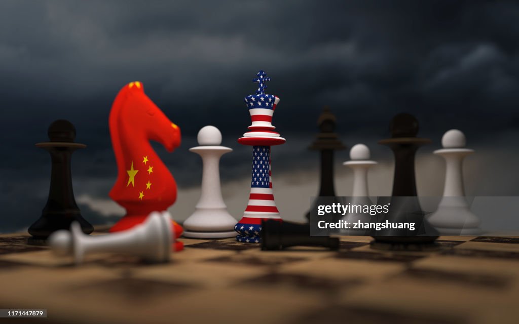 USA and China trade relations, cooperation strategy. US America and China flags on chess king on a chessboard.