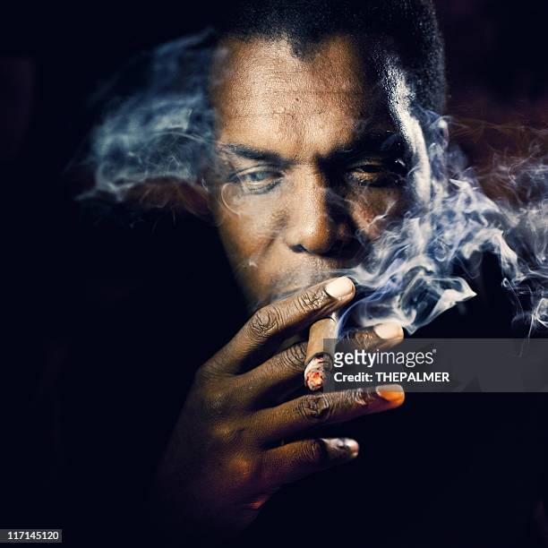 man smoking a cigar - cigar smokers stock pictures, royalty-free photos & images