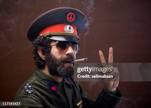 Pacifist general in military officier uniform making peace sign