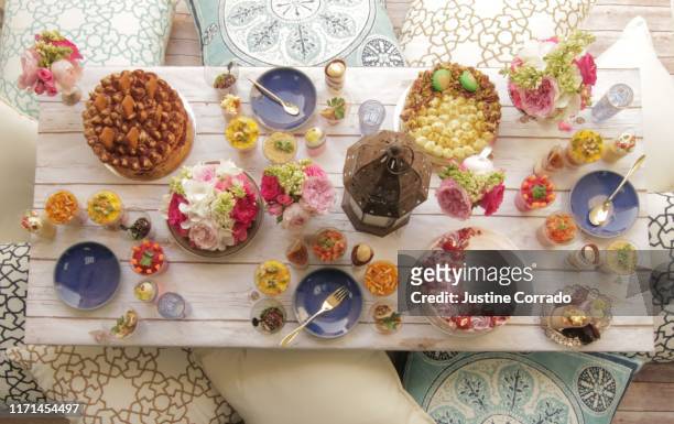 ramadan table setting with floor cushions, cakes, place settings with savory and sweet food - sweet and savory food stock pictures, royalty-free photos & images
