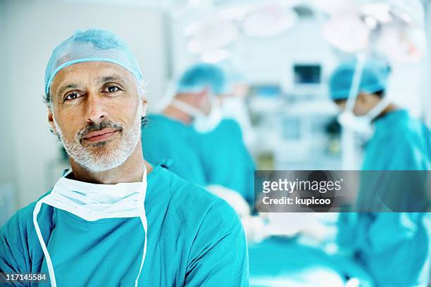 doctor smiling in operating theater - patient portrait stock pictures, royalty-free photos & images