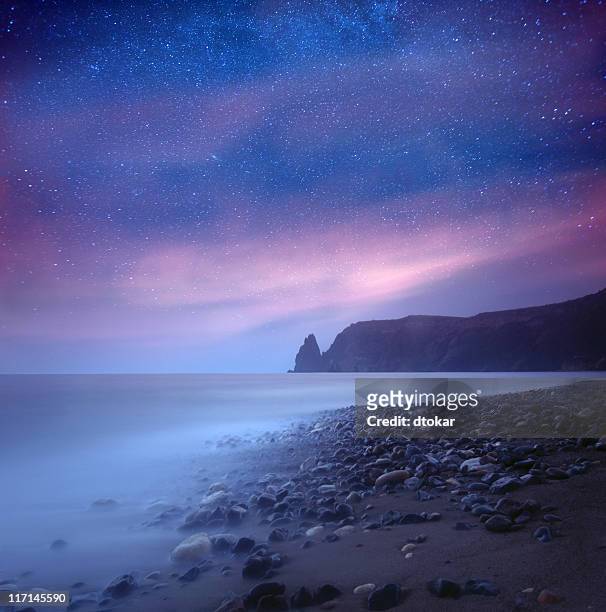 sea at night under milky way stars - beauty in nature beach fantasy stock pictures, royalty-free photos & images