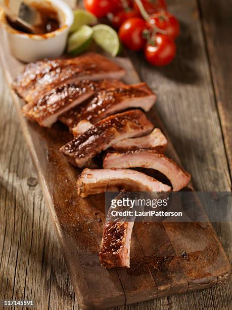 baby back pork ribs on a cutting board - spareribs stock pictures, royalty-free photos & images
