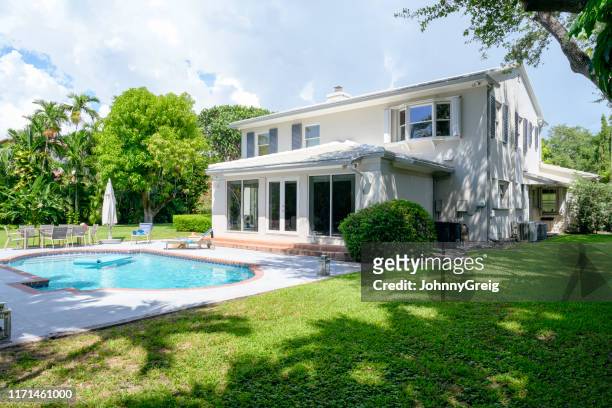 modern two-story home in miami with yard and swimming pool - swimming pool stock pictures, royalty-free photos & images