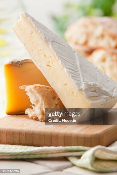 cheese stills: brie, tomme and bread - french cheese stock pictures, royalty-free photos & images