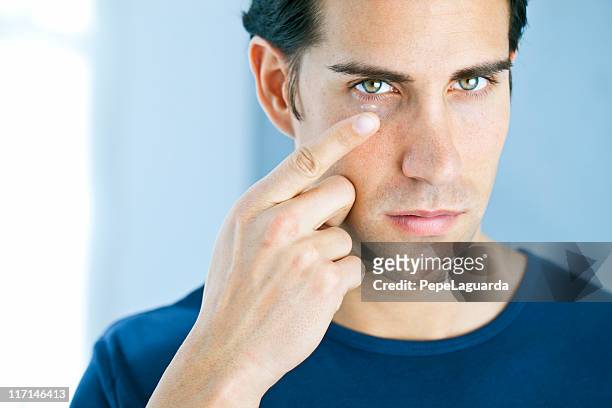 vision: man using a contact lens - contact lens stock pictures, royalty-free photos & images