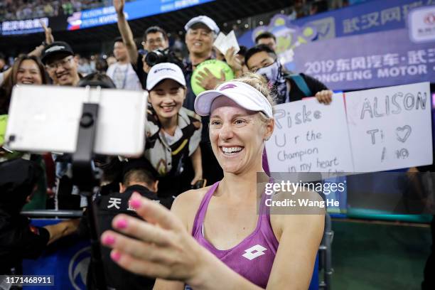 Alison Riske of the United States takes photos with fans after winning the Singles Semifinal match against Petra Kvitova of Czech on Day 6 of 2019...