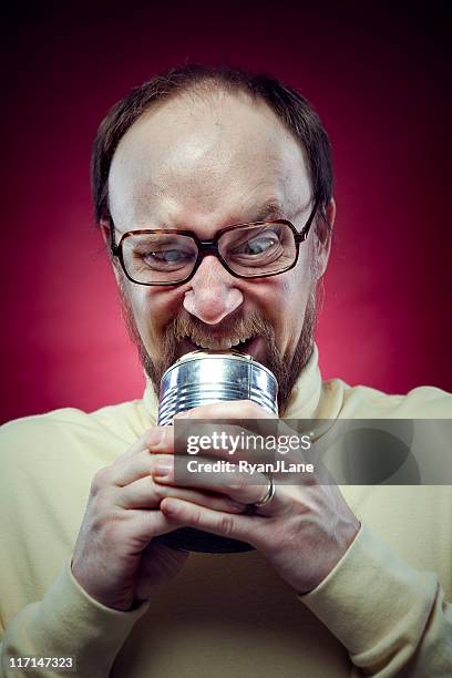 nerdy man opening can with teeth - all you can eat stock pictures, royalty-free photos & images