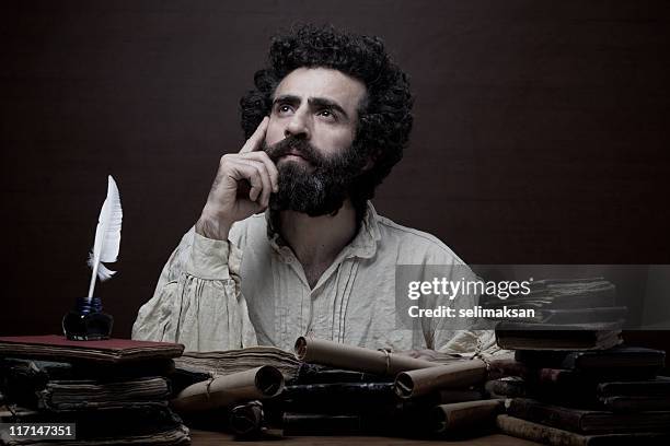 adult man with beard in medieval costume thinking for inspiration - philosophy book stock pictures, royalty-free photos & images